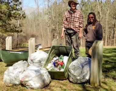 Volunteers with trash from campsite cleanup