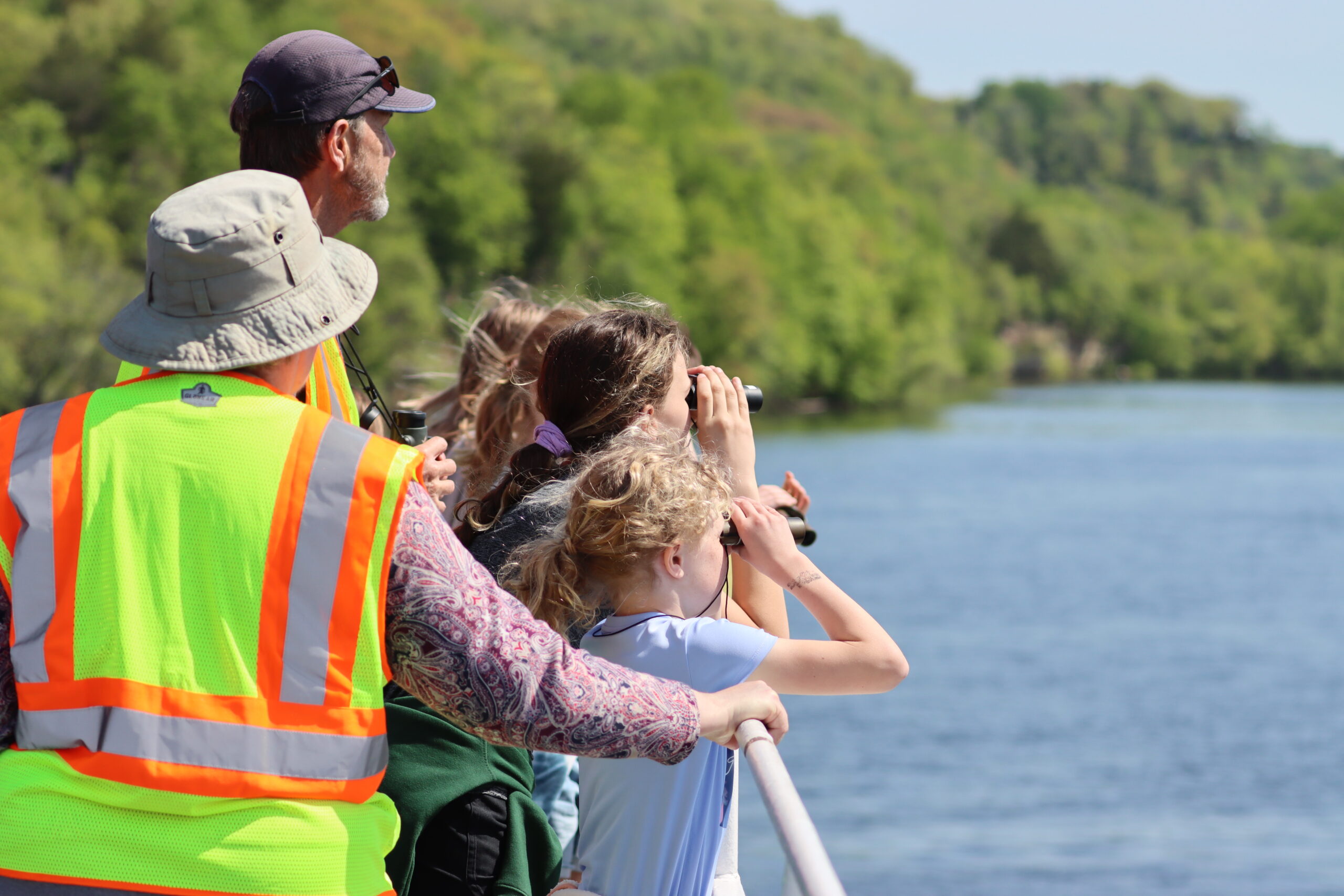 Youth (4th graders) participating in a bird watching class on the St.Croix River, part of Wild River Journey programming.