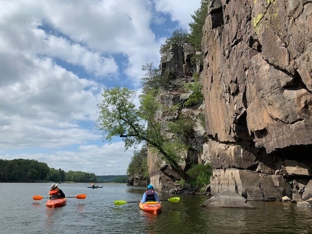 Paddlers inspect the rock formations on the St. Croix near Taylors Falls during the 2023 “Birding by Sound” paddle. Photo: Katie Sickmann, Wild Rivers Conservancy