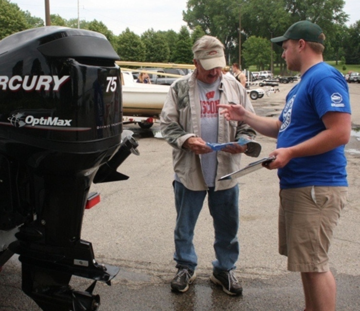 A watercraft inspector volunteer gives instructions to boater.