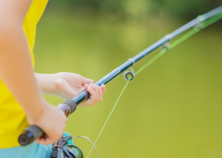 A girl holds a fishing pole
