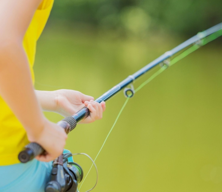 A girl holds a fishing pole