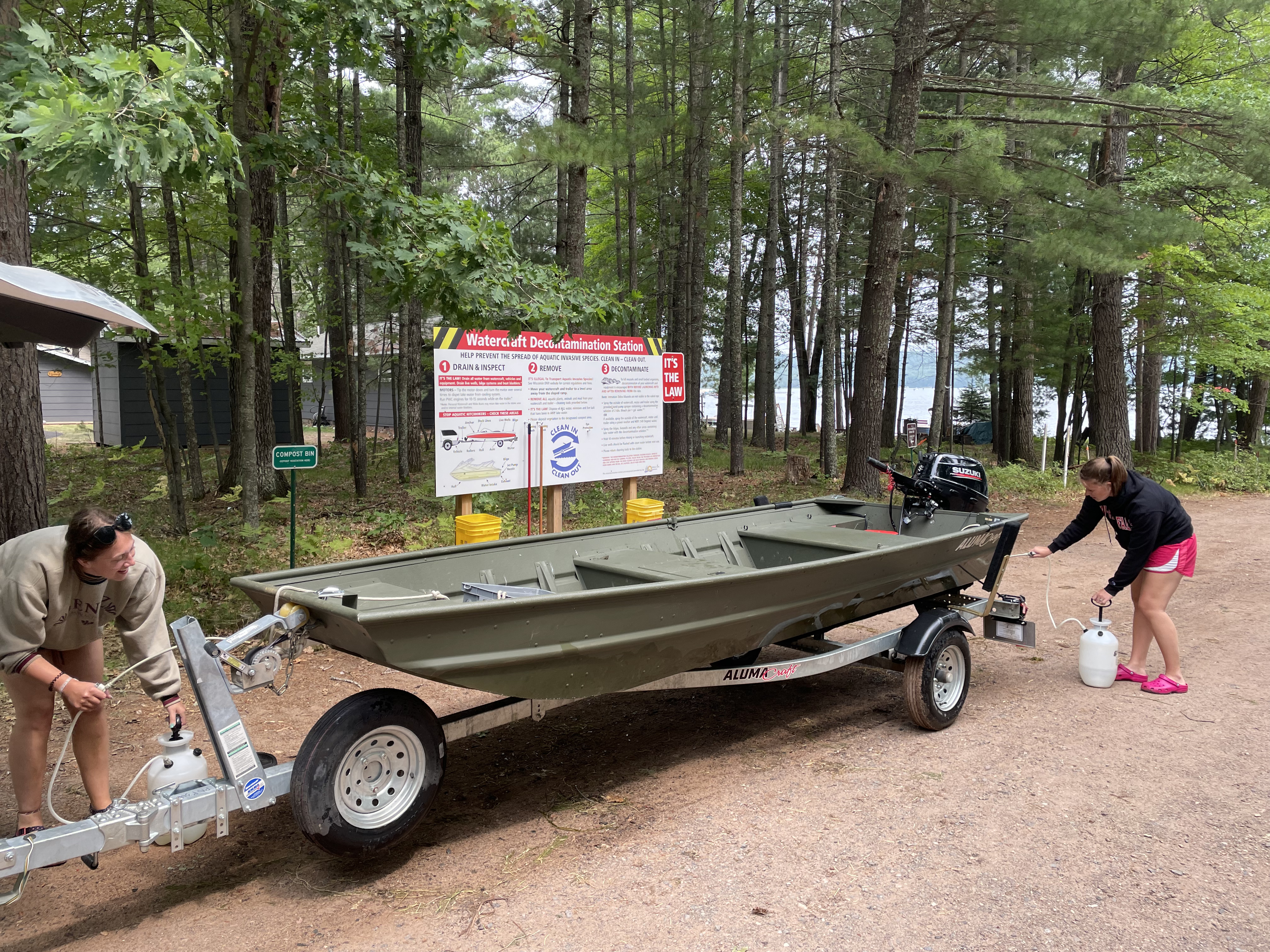 Recreationists using a boat cleaning station to decontaminate their watercraft after a day on the water.